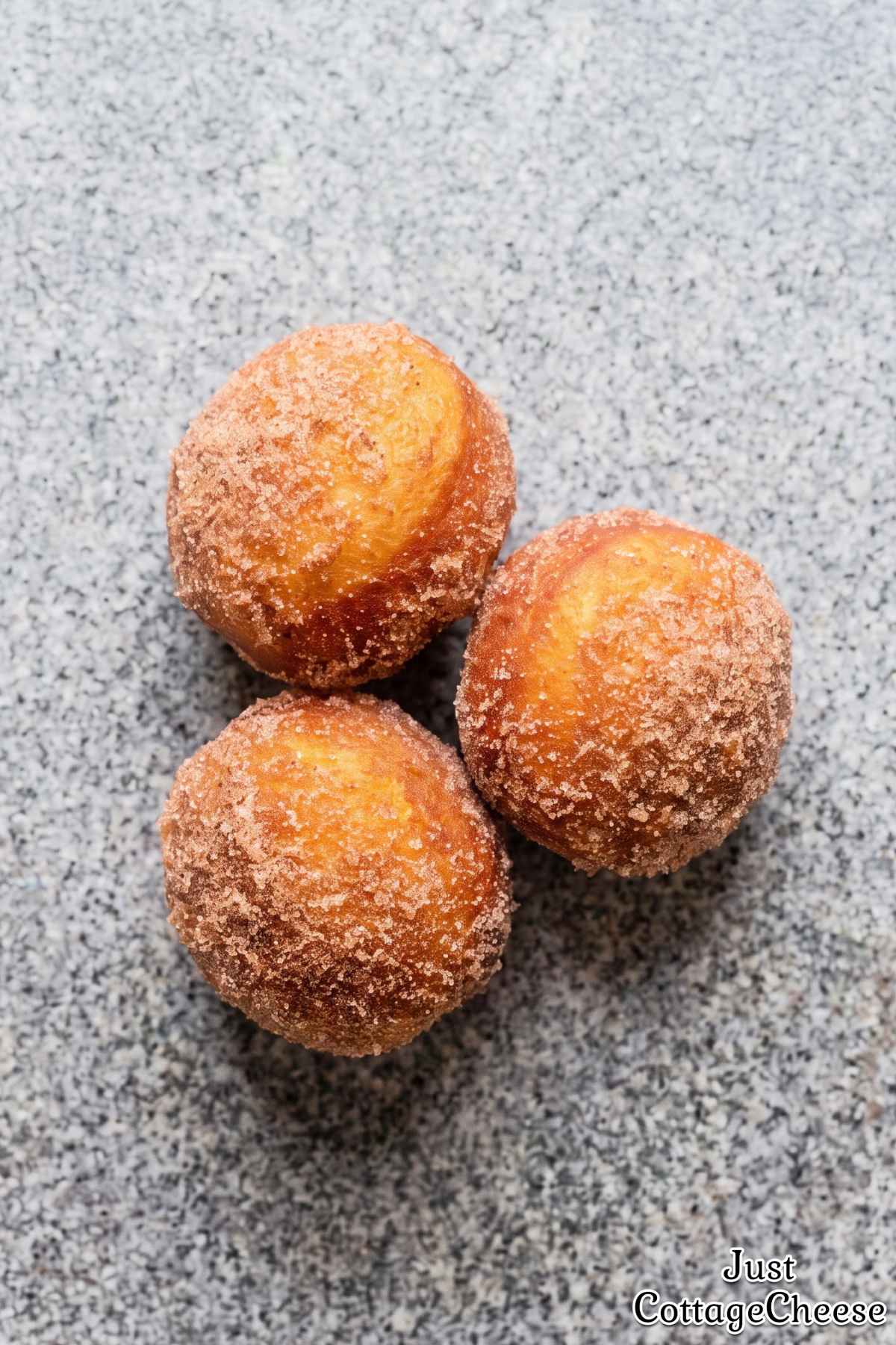 Warm cinnamon sugar donut bites on a plate