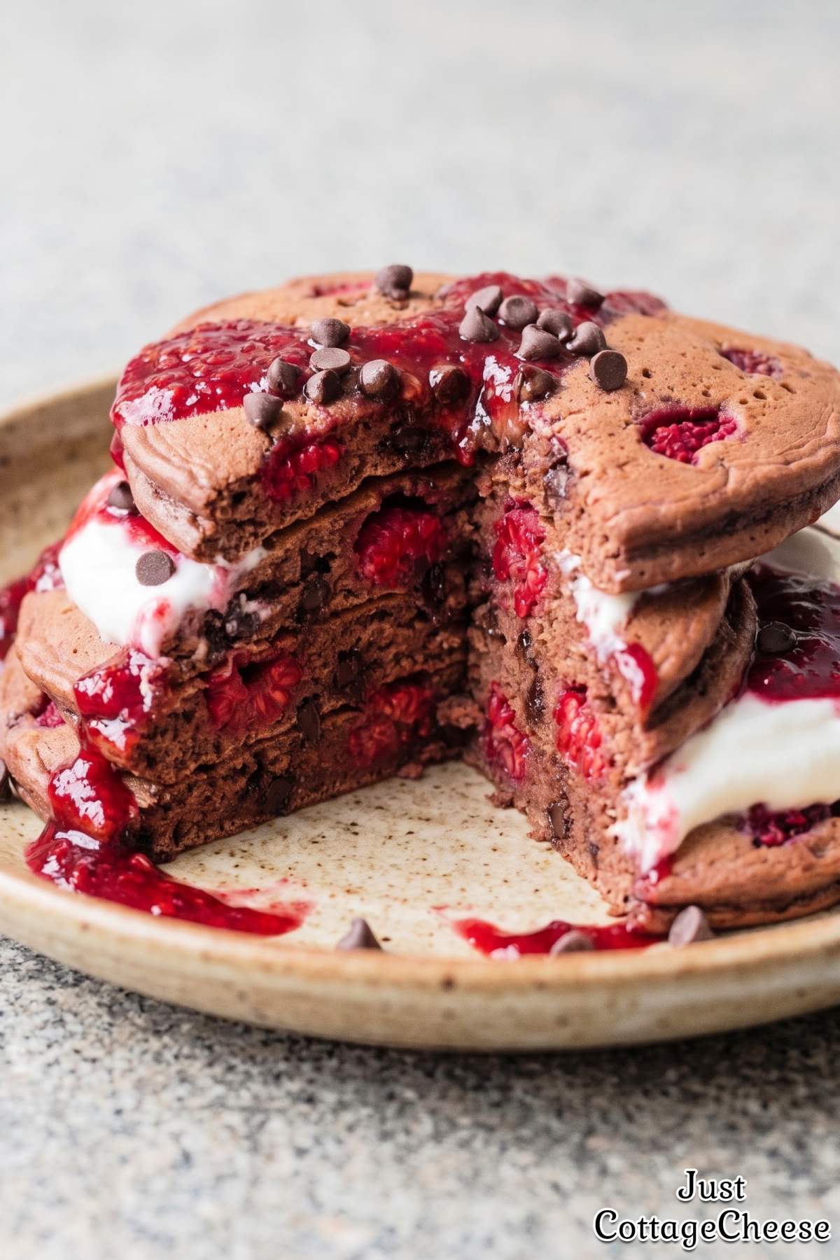 Warm chocolate protein pancakes with raspberries