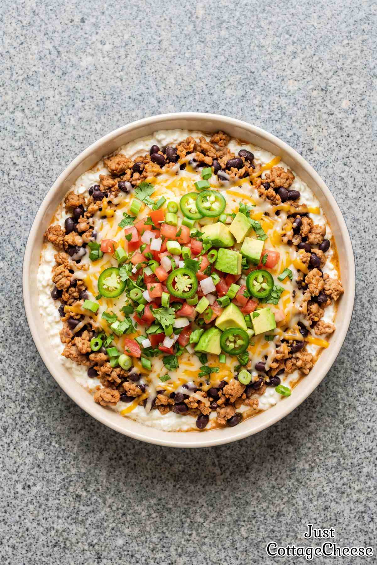Savory protein taco dip with tortilla chips.