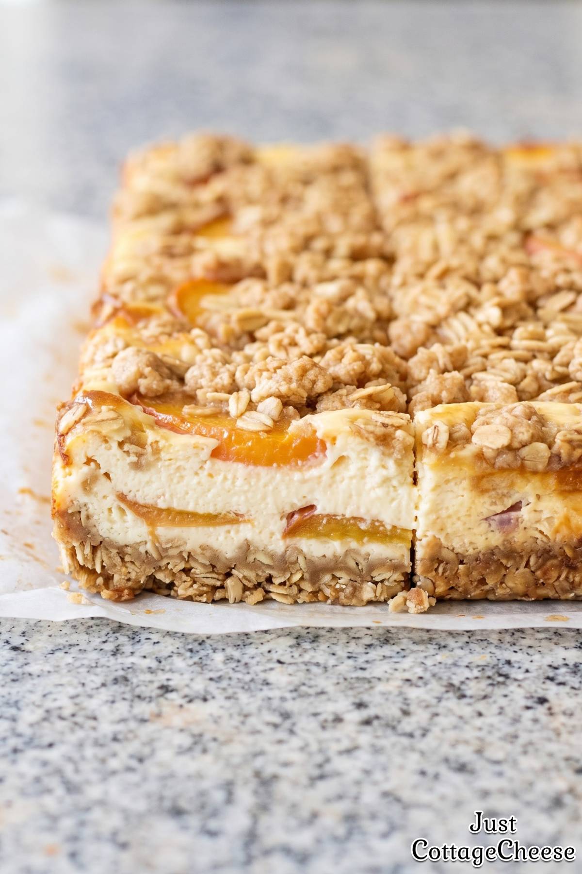 Fresh peach cobbler cheesecake bars on plate