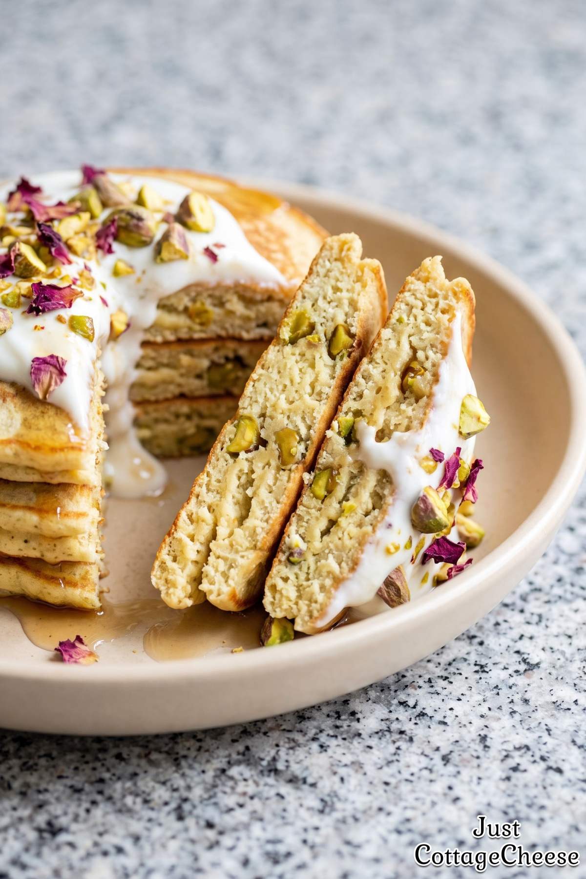 Pistachio rose protein pancakes on a plate.