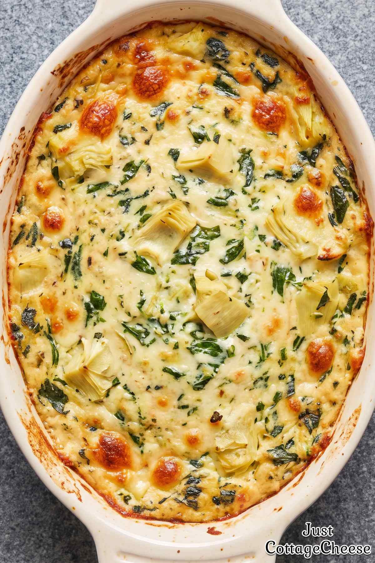 Warm protein spinach artichoke dip in a bowl