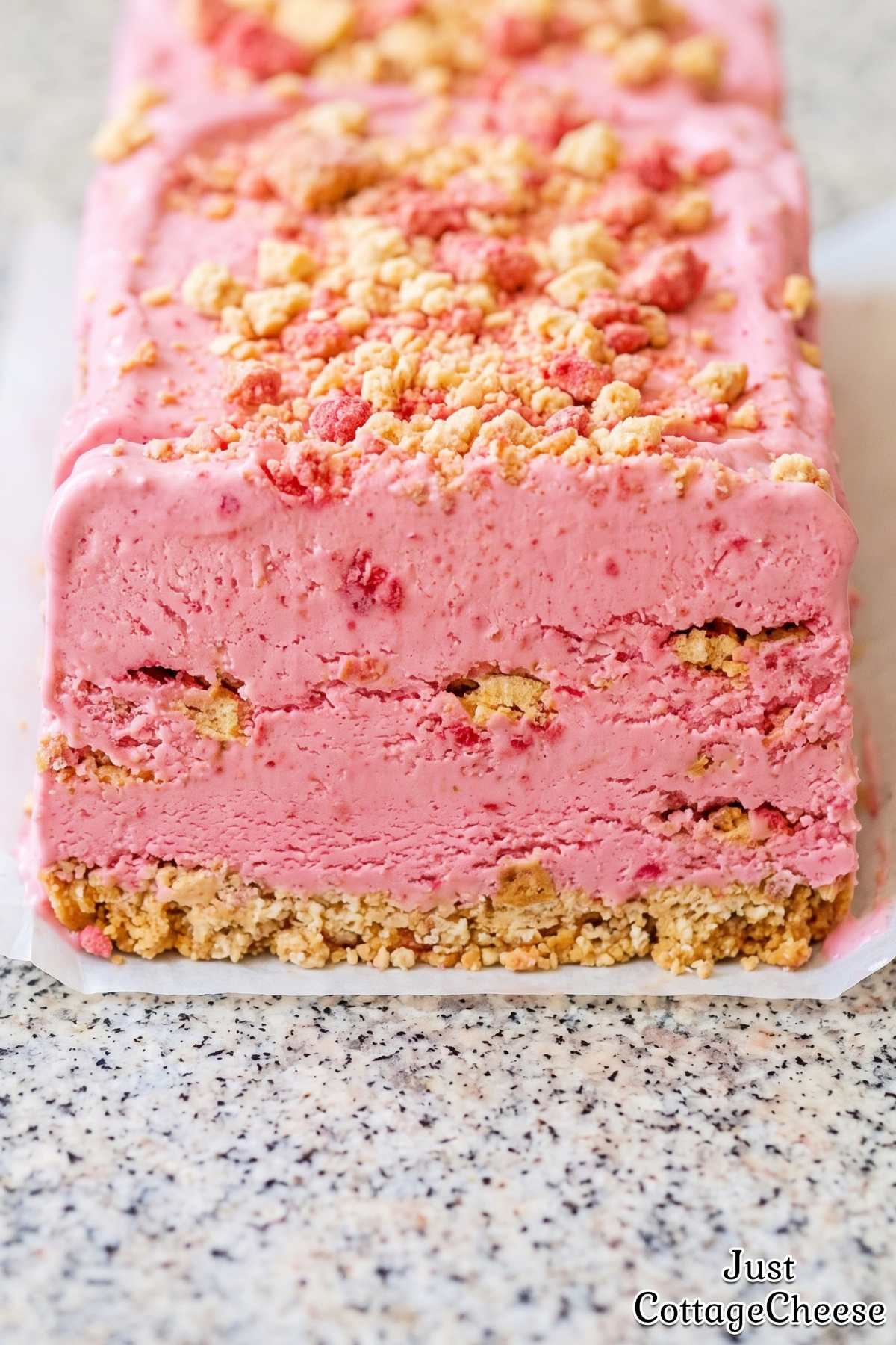 Scoop of strawberry crunch protein ice cream